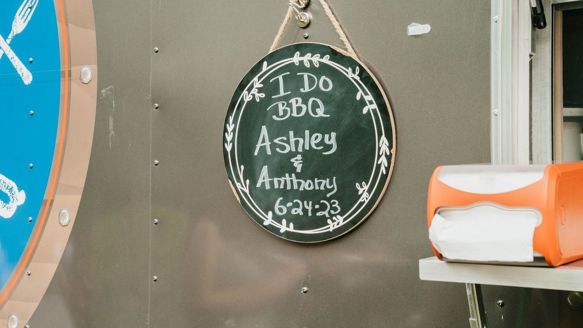 A chalkboard reads I Do BBQ with Ashley and Anthony’s names