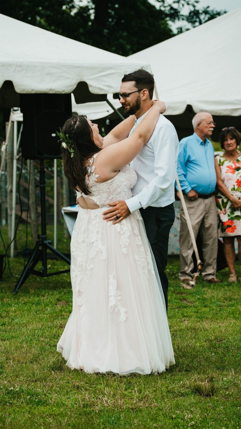 A full-length photograph of Ashley and Anthony dancing outdoors