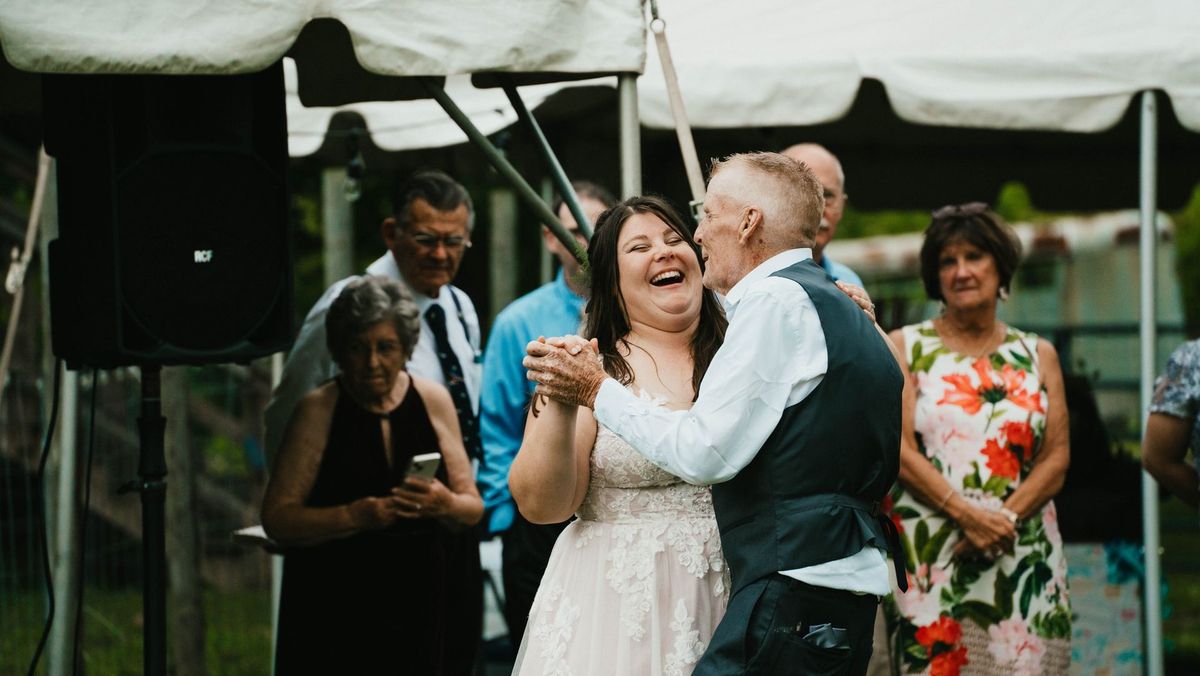 Ashley laughs while dancing with a loved one