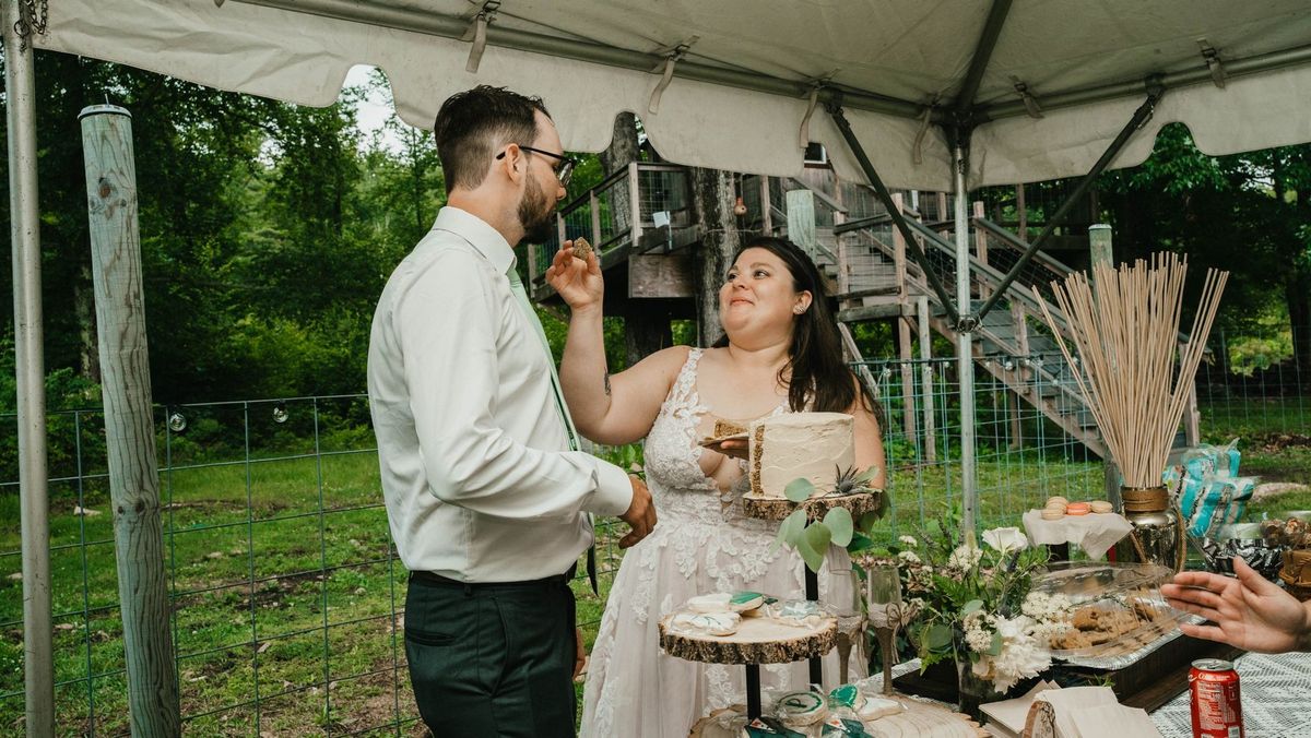 Anthony offers Ashley a bite of wedding cake
