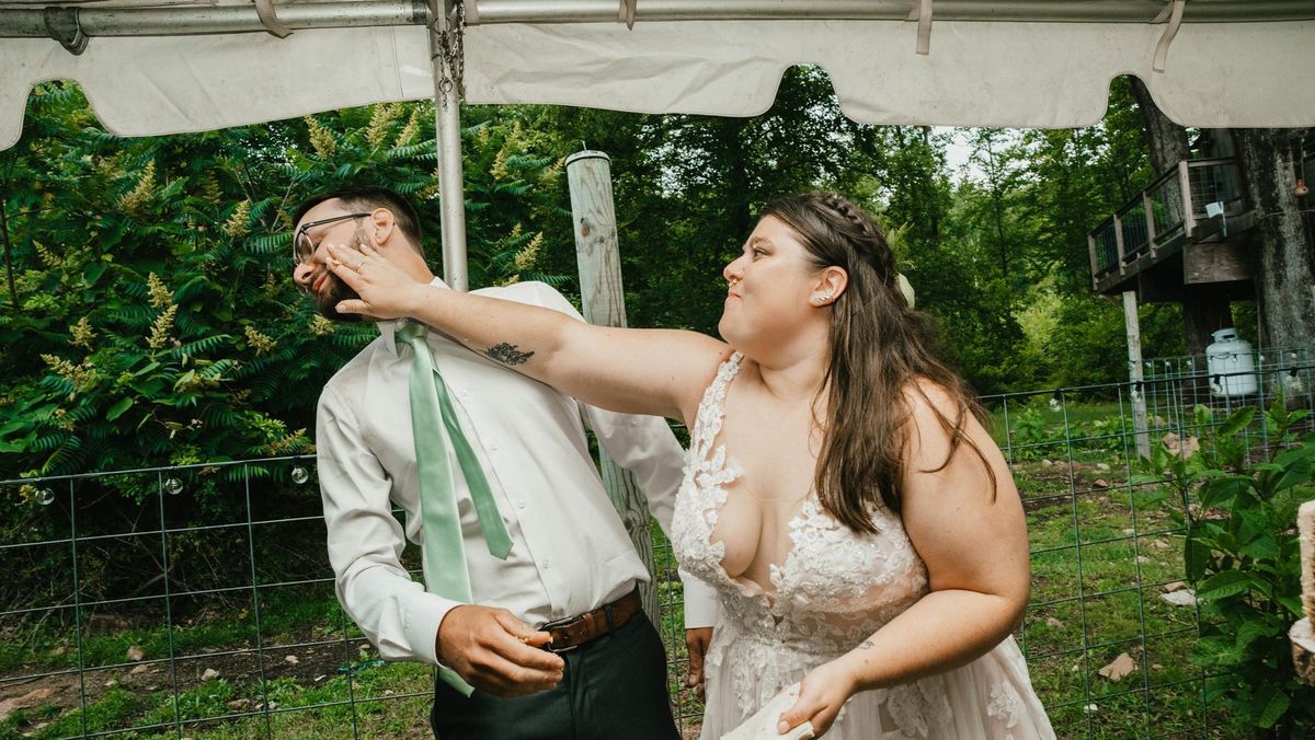 Ashley feeds Anthony a bite of wedding cake