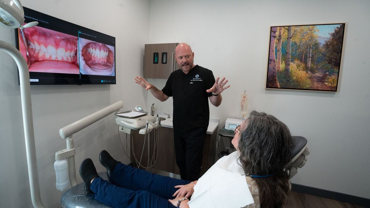 Man in black scrubs gesturing in a BPS Periodontics treatment room