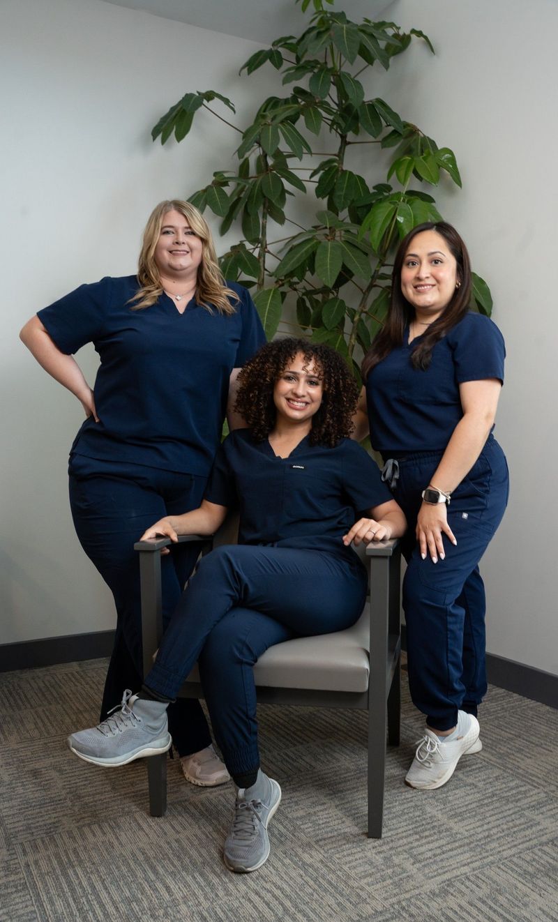 Three members of the BPS Periodontics team posed together in a group portrait