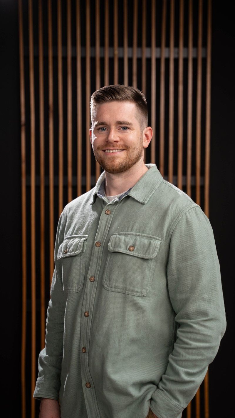 Brooke Team member in a green shirt smiling toward the camera