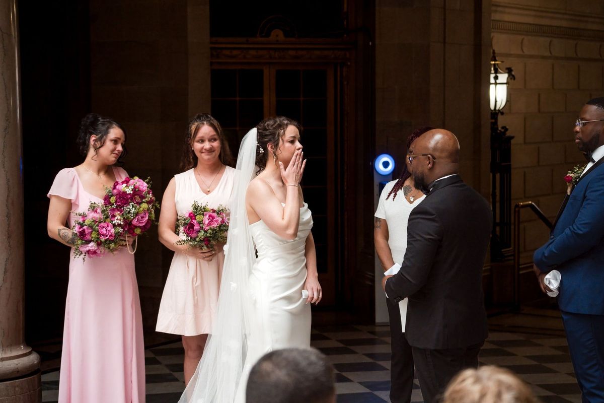 Christina lifts a hand to her face during the ceremony
