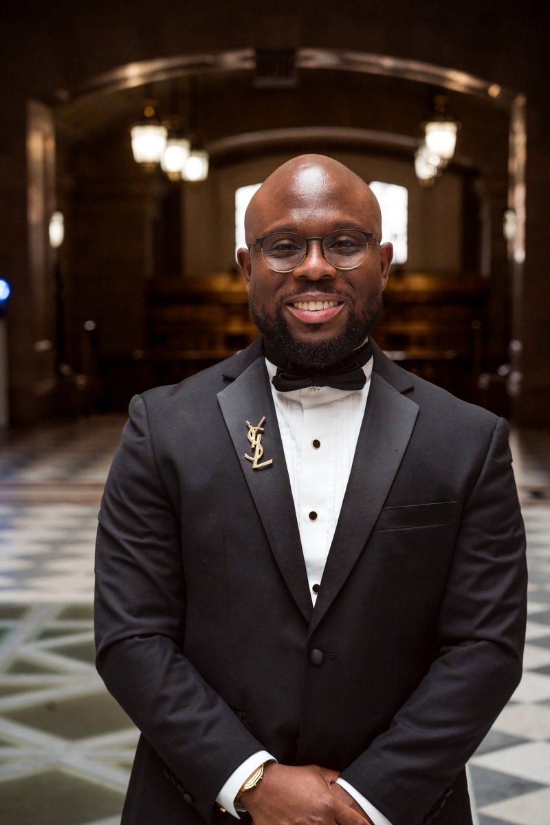 Tajay faces the camera in a close portrait on the patterned City Hall floor