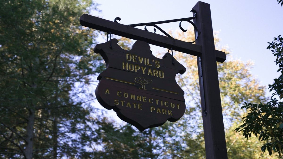 A hanging sign introduces Devil’s Hopyard State Park