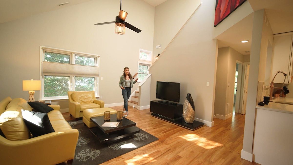 A bright living room with a vaulted ceiling