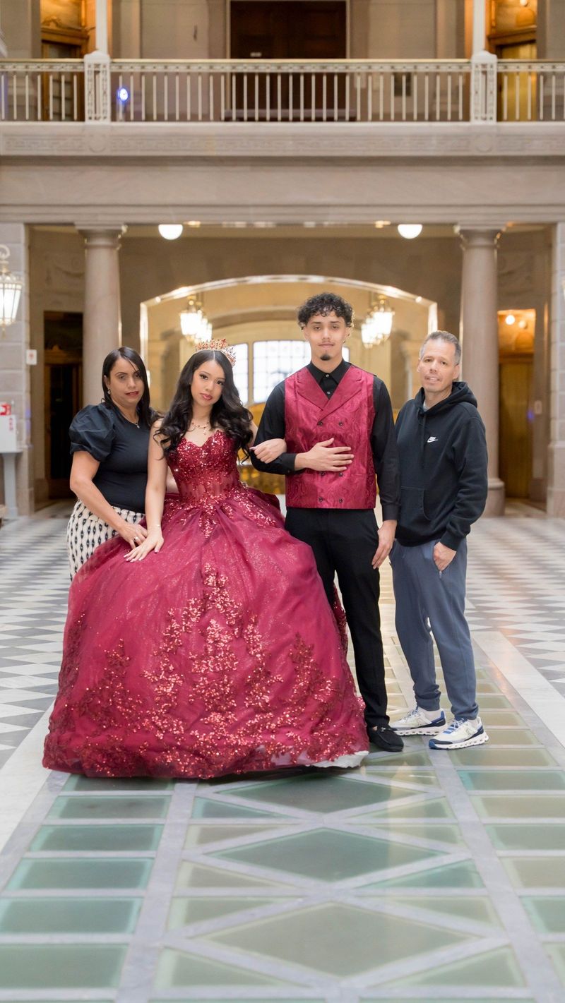 Genesis poses with three companions in the Hartford City Hall atrium