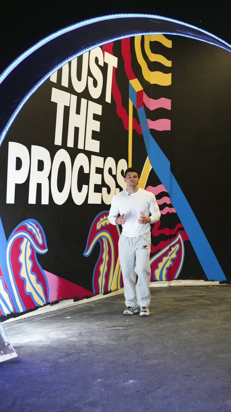 Illuminated Trust the Process wall at GF Fitness — video frame