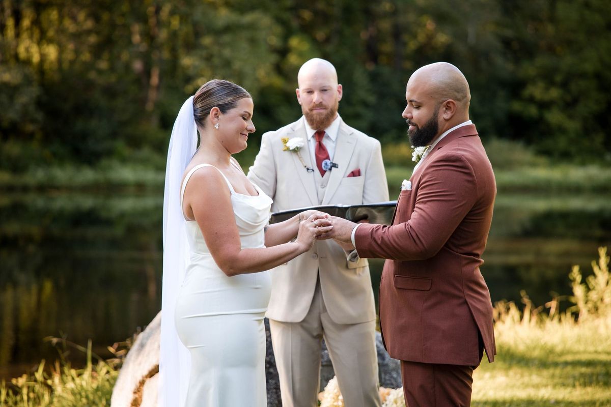 A close view of the couple’s hands during their ring exchange