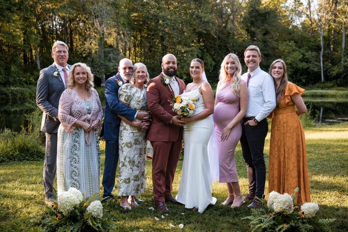 Jacob and Thea gather with a large group of loved ones by the pond