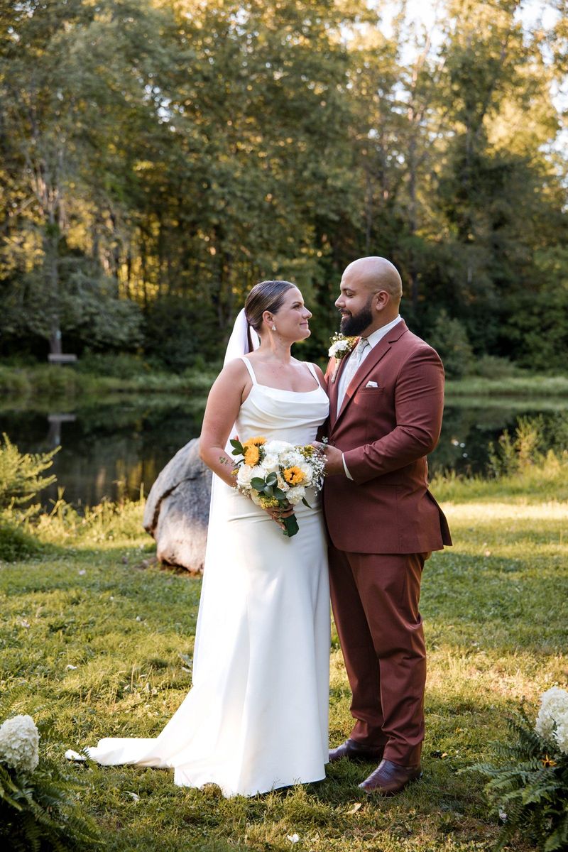 Jacob and Thea face one another in a full-length portrait by the pond