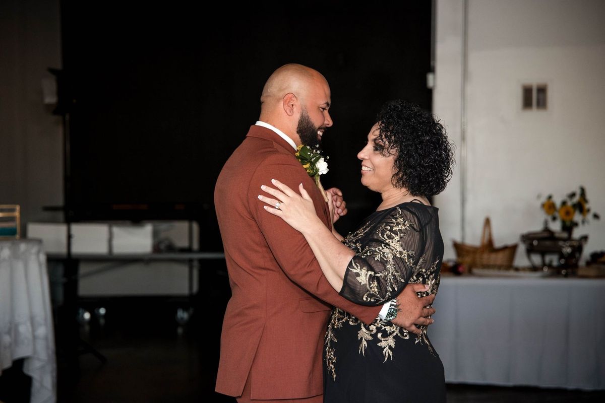 Jacob dances with a loved one in a black and gold dress