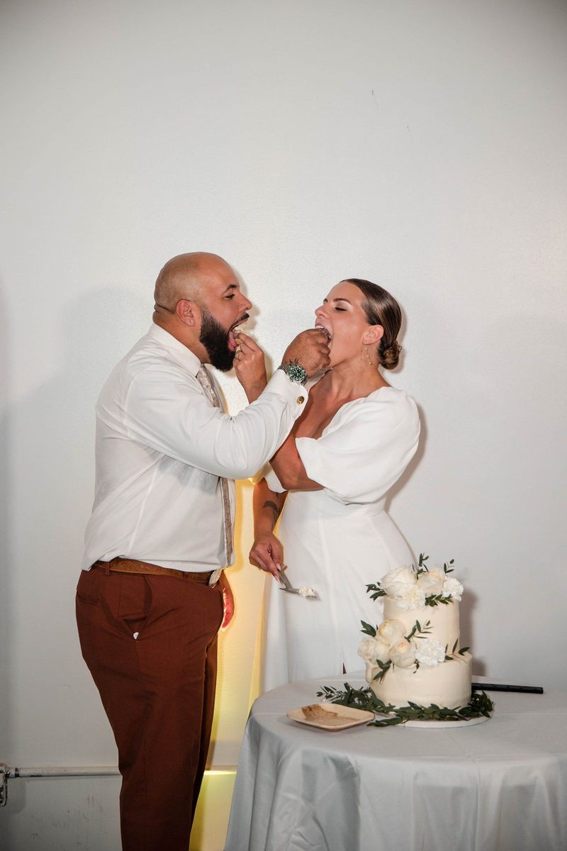 Jacob and Thea share cake together beside the flower-decorated cake