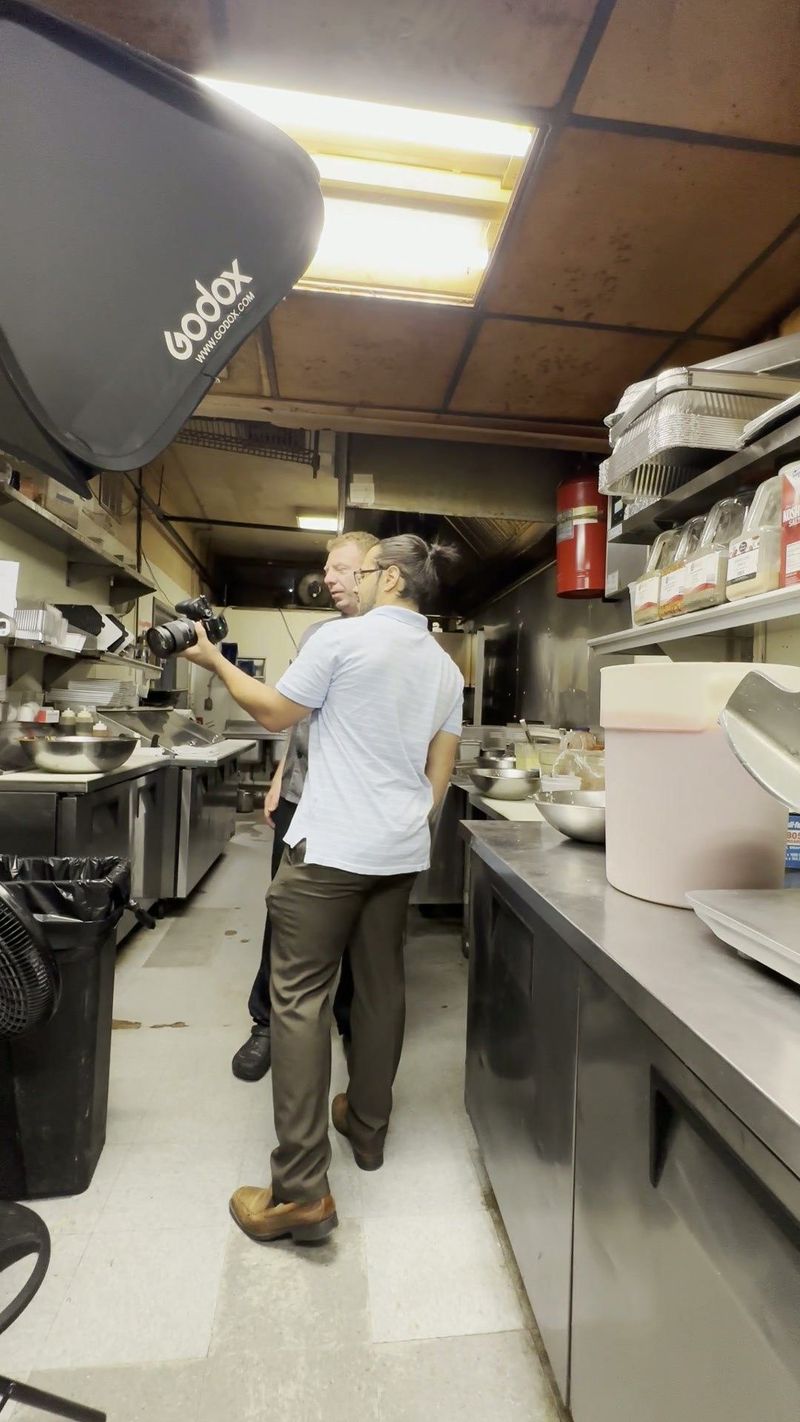 Behind the scenes at Luna's Pizza with a photographer and softbox in the kitchen