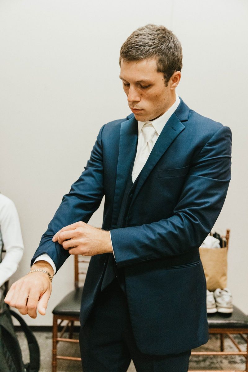 Max adjusting his cuff while getting ready