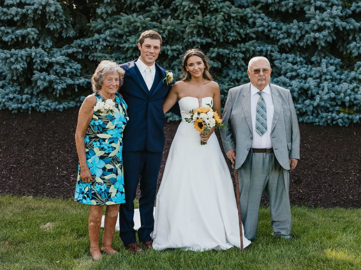 Mariana and Max posing with two loved ones