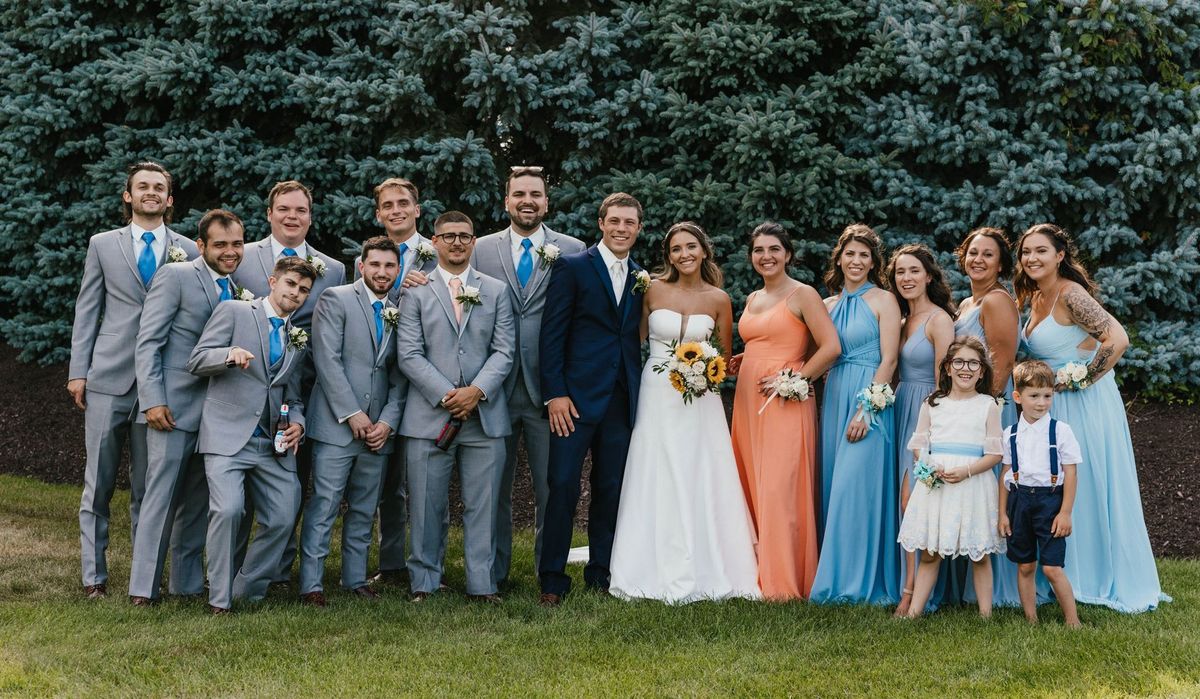 Mariana and Max with their wedding party outdoors