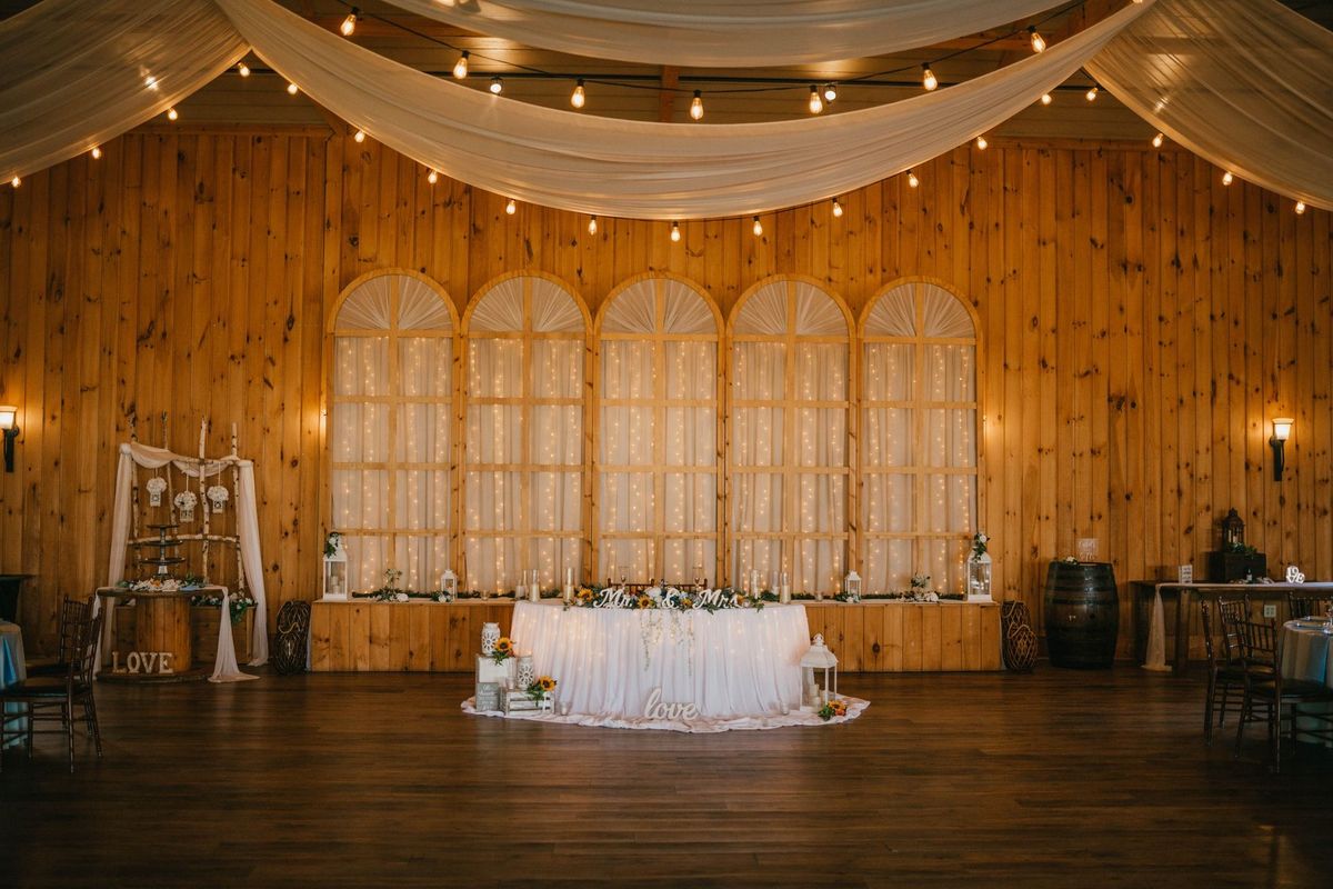 The reception room with draping, wooden walls and string lights