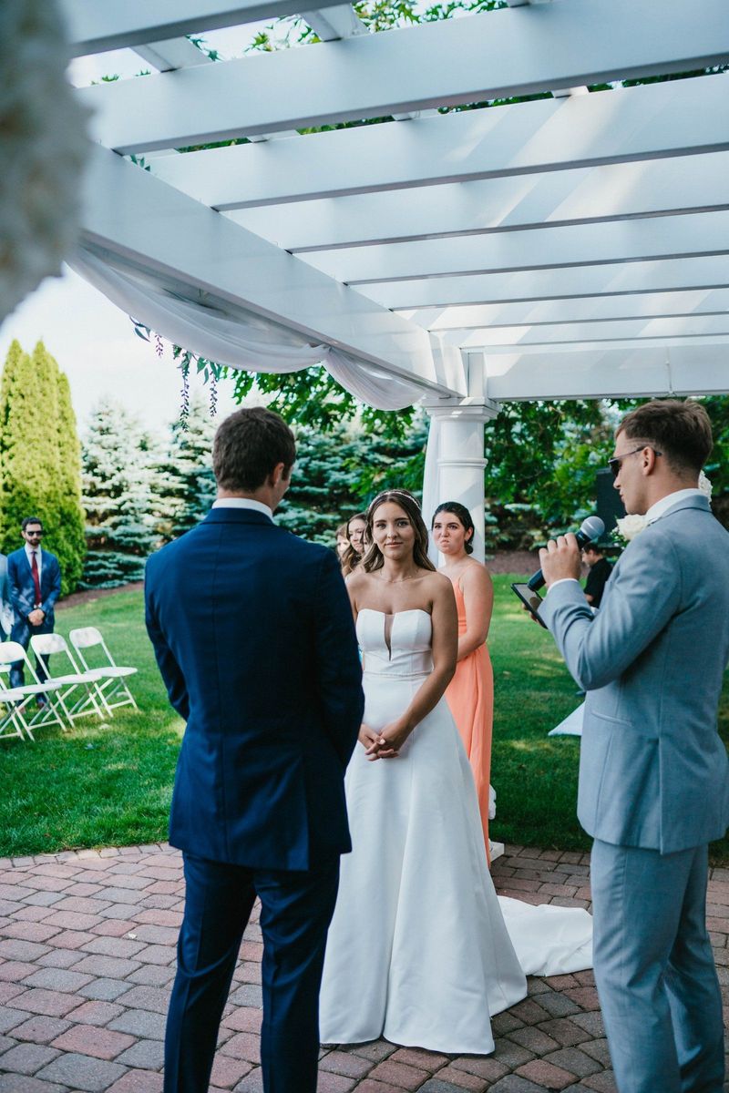Mariana listening during the outdoor ceremony