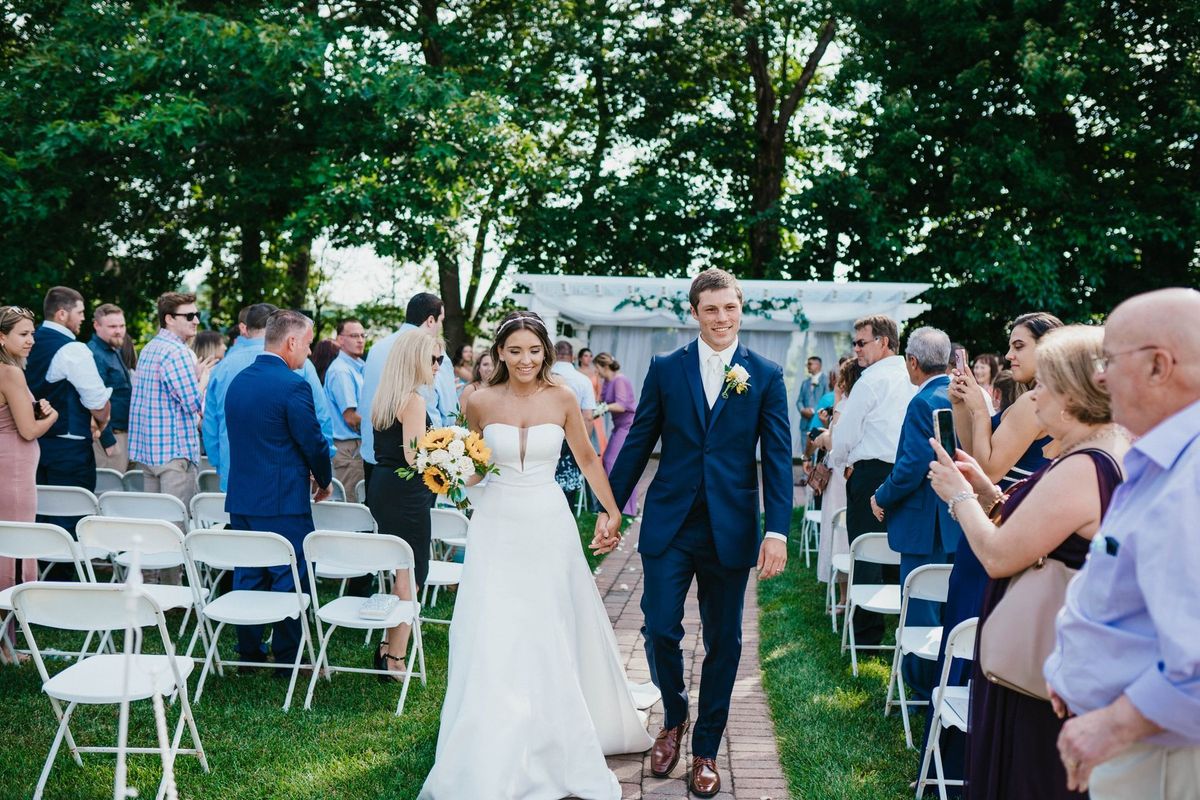Mariana and Max walking back down the aisle