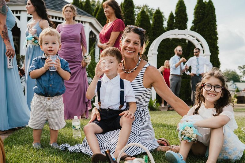 Guests and children seated together on the grass