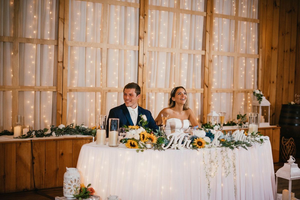 Mariana and Max reacting at their reception table