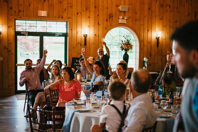 Reception guests raising their glasses for a toast
