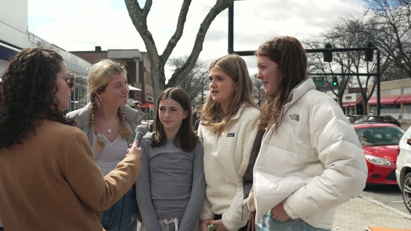 Robyn interviews a group on a West Hartford sidewalk