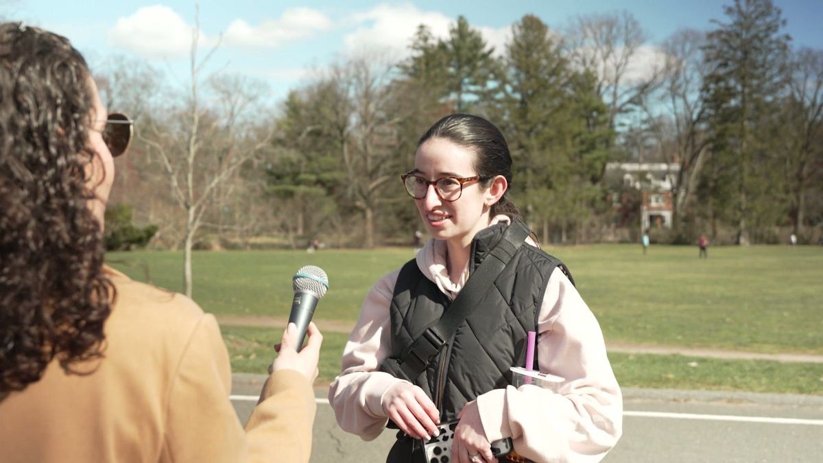 A guest speaks with Robyn in a park