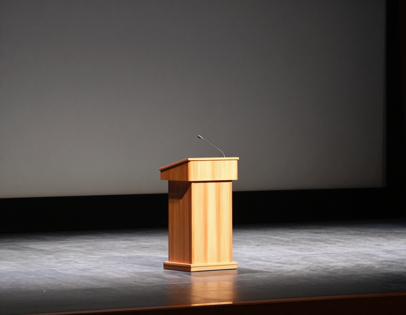 Illustration of an empty podium and microphone on a lit stage