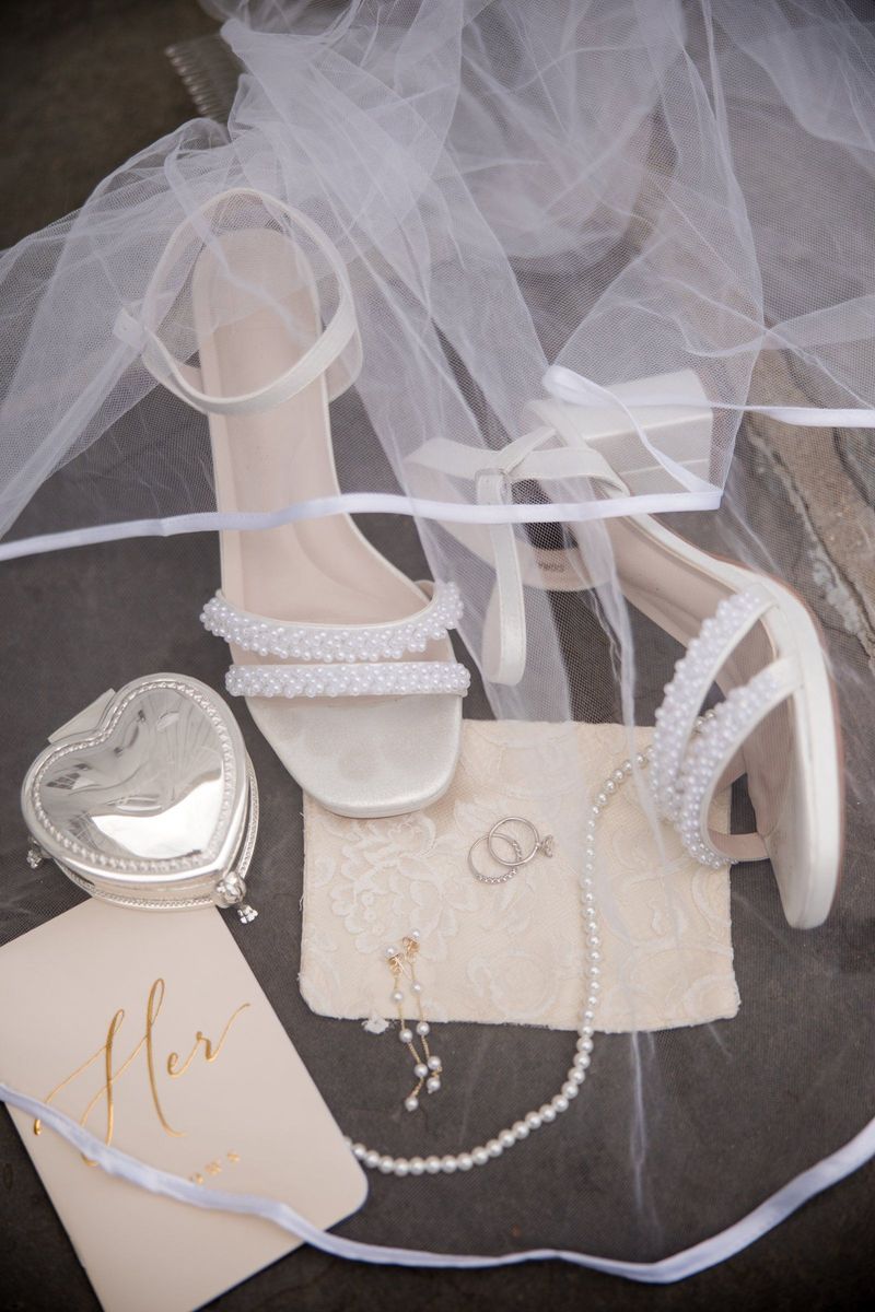 Sadie’s shoes, jewelry and vow book arranged beneath her veil