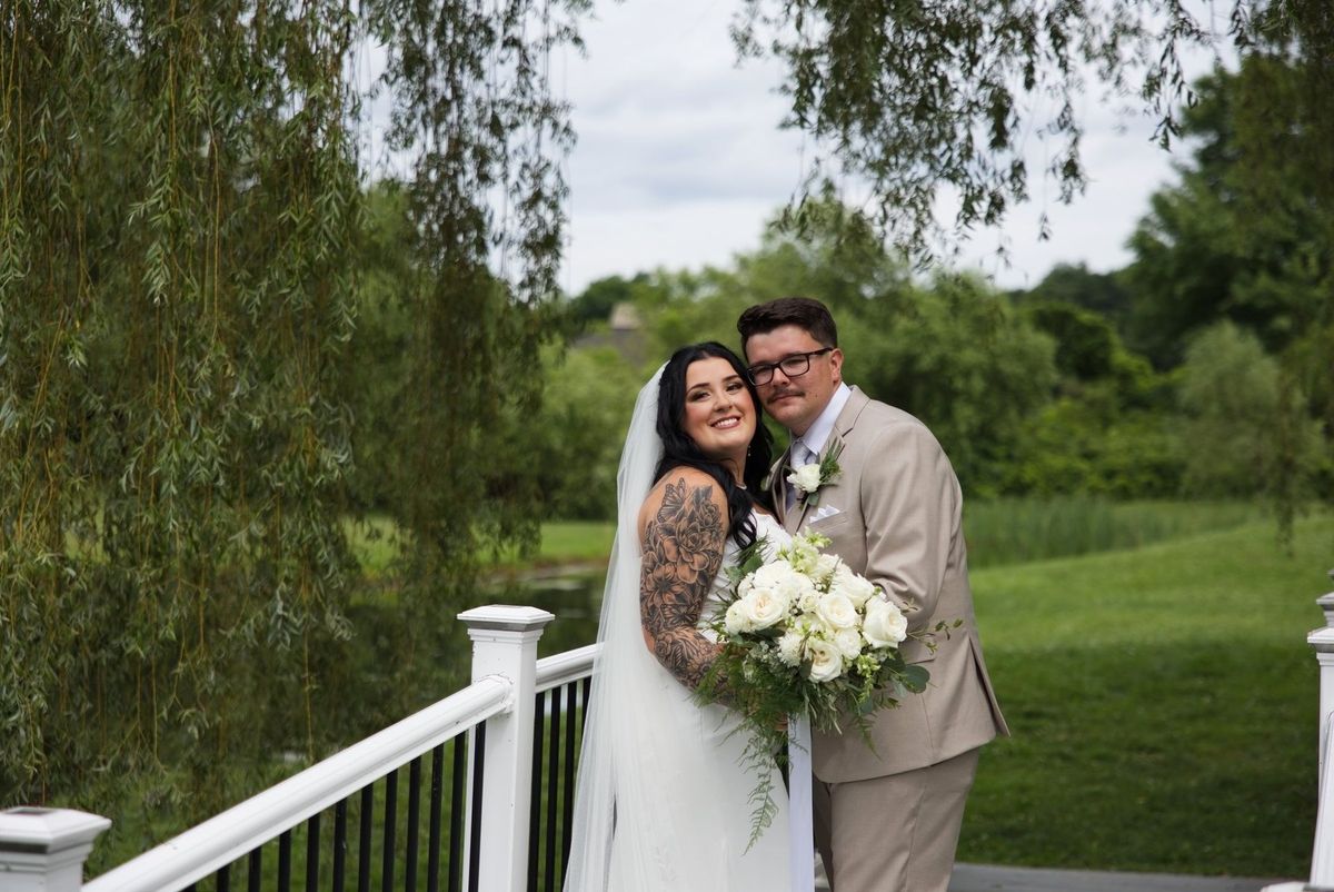 Sadie and Mat smile together beside the pond