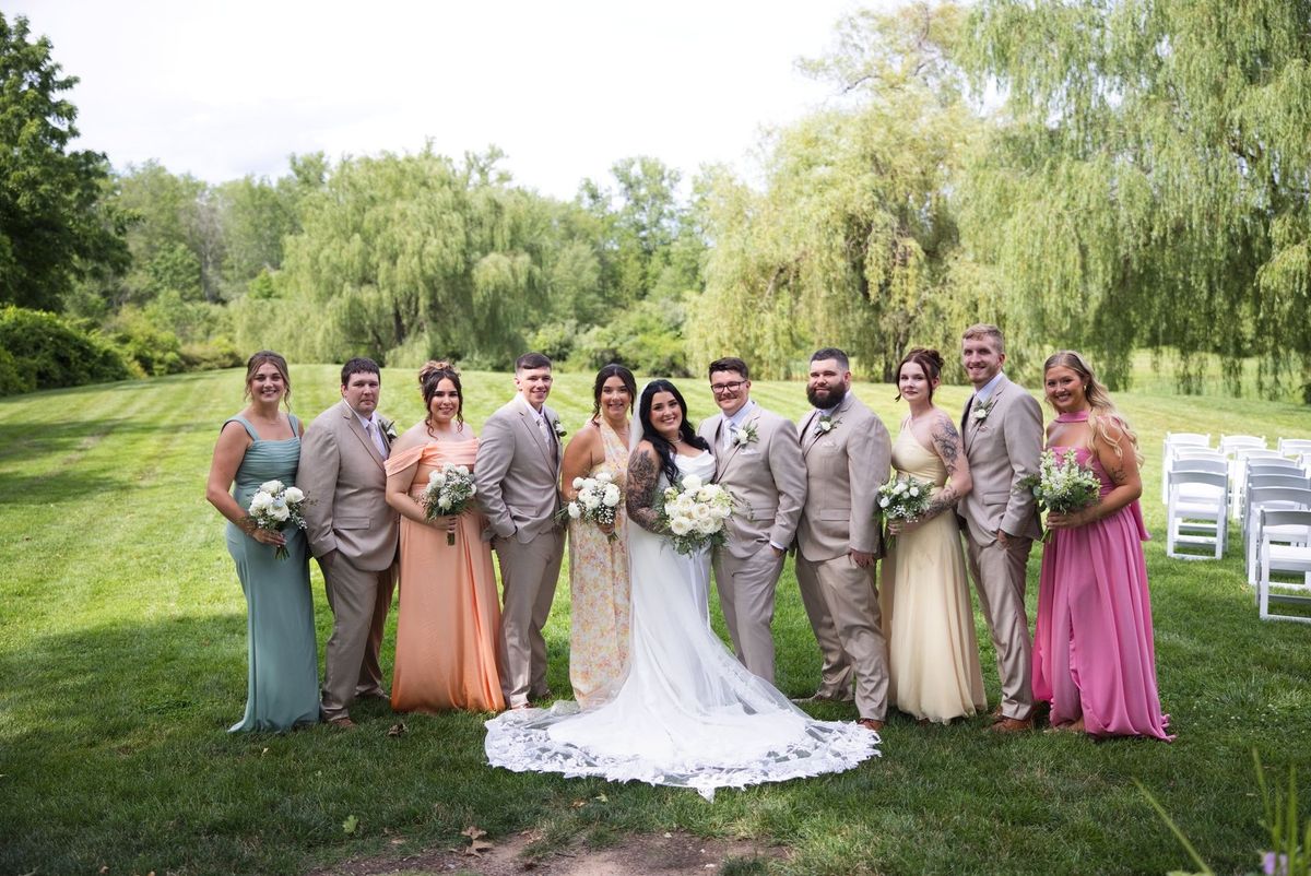 Sadie and Mat with their wedding party beside the ceremony lawn
