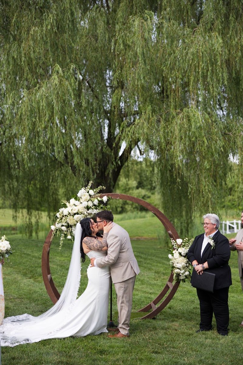 Sadie and Mat kiss during their outdoor ceremony