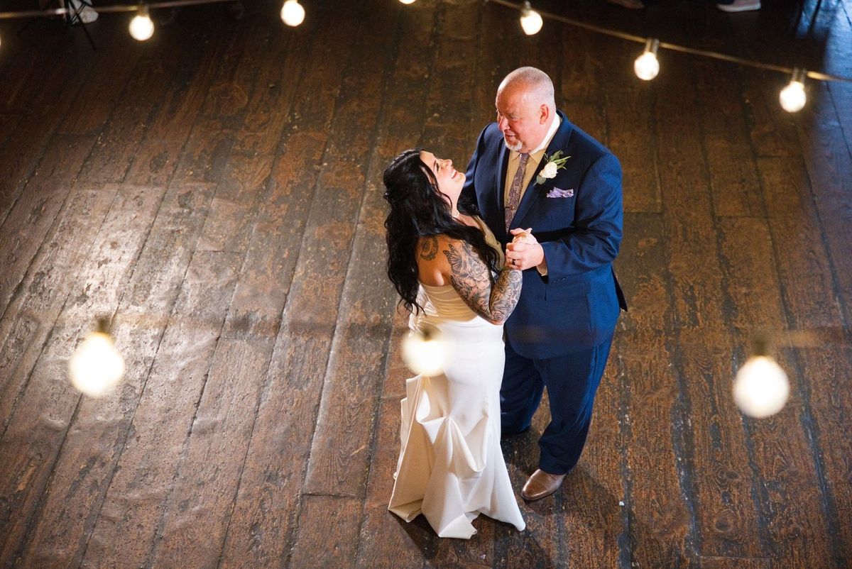 Sadie dances with a family member on the barn’s wooden floor