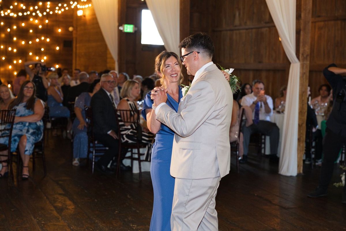 Mat smiles while dancing with a family member at the reception