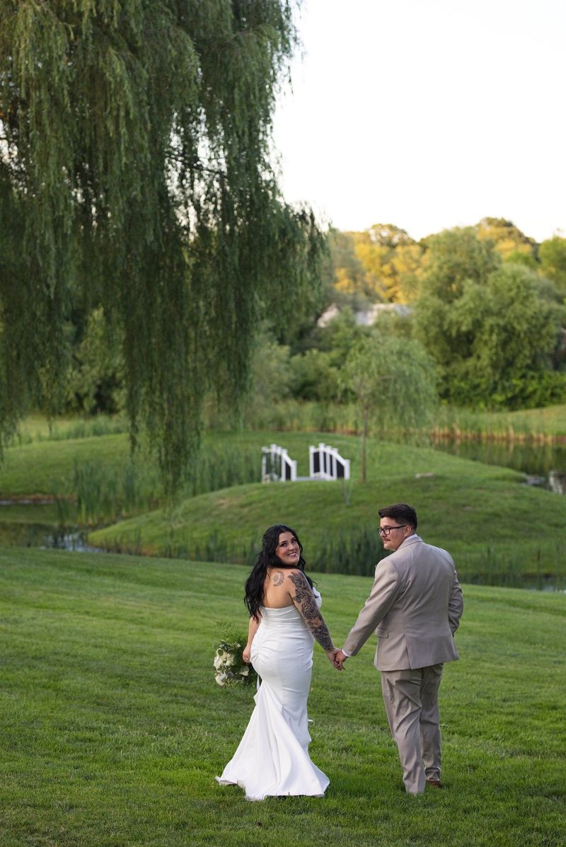 Sadie and Mat look back while walking beside the pond in the evening