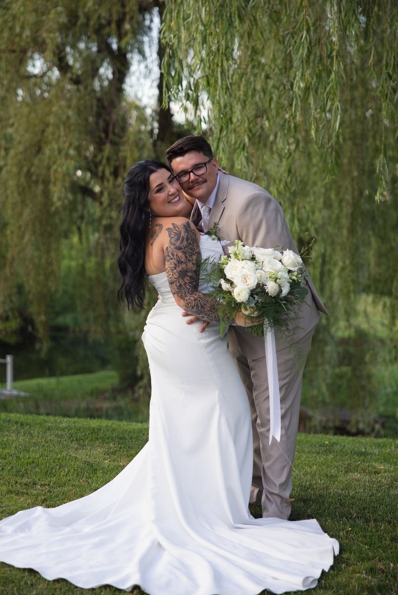 Sadie and Mat embrace beneath the willows in the evening