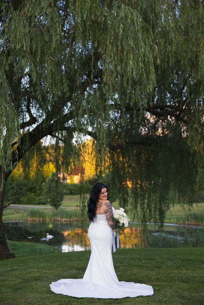 Sadie’s bridal portrait with willow branches and warm light across the pond