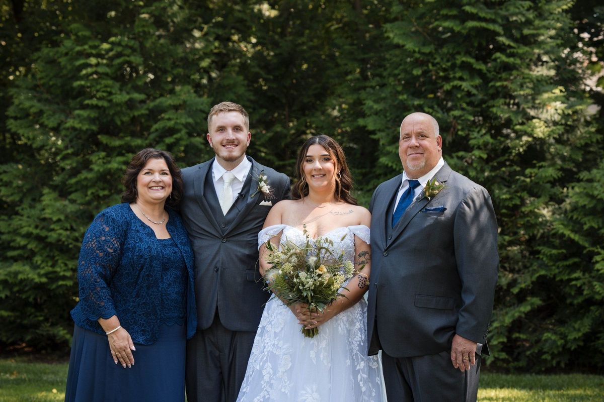 Sophia and Tommy pose with two companions on the garden lawn
