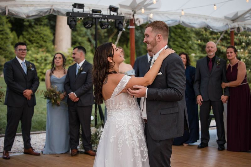 Sophia and Tommy dance closely together as their wedding party watches