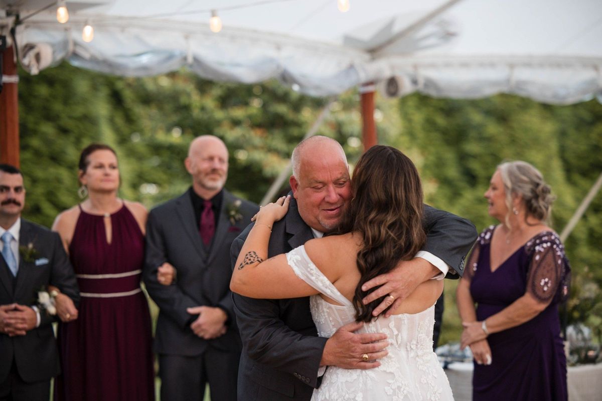 Sophia embraces a guest on the reception dance floor