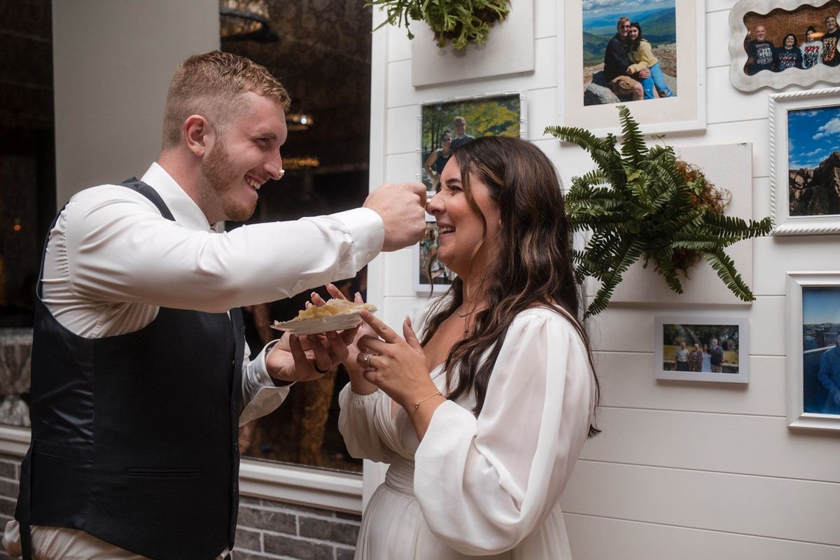 Tommy offers Sophia a bite of cake as they smile together