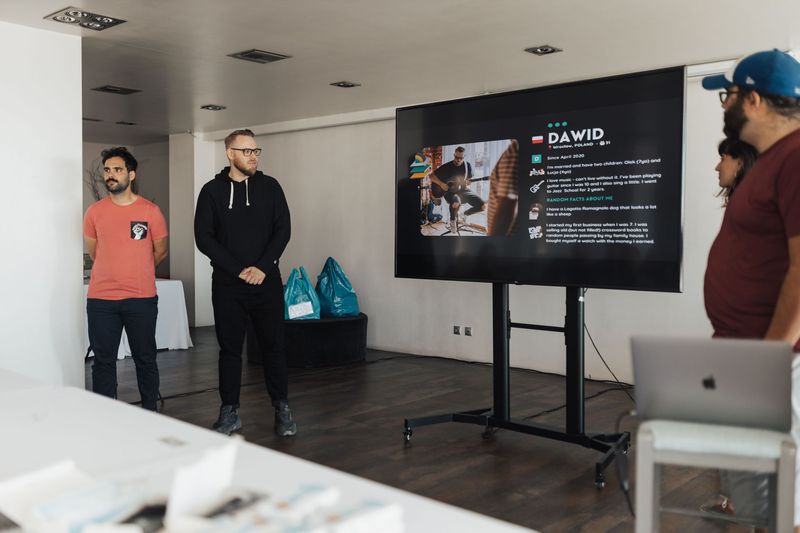 A man presents to his team in a modern office