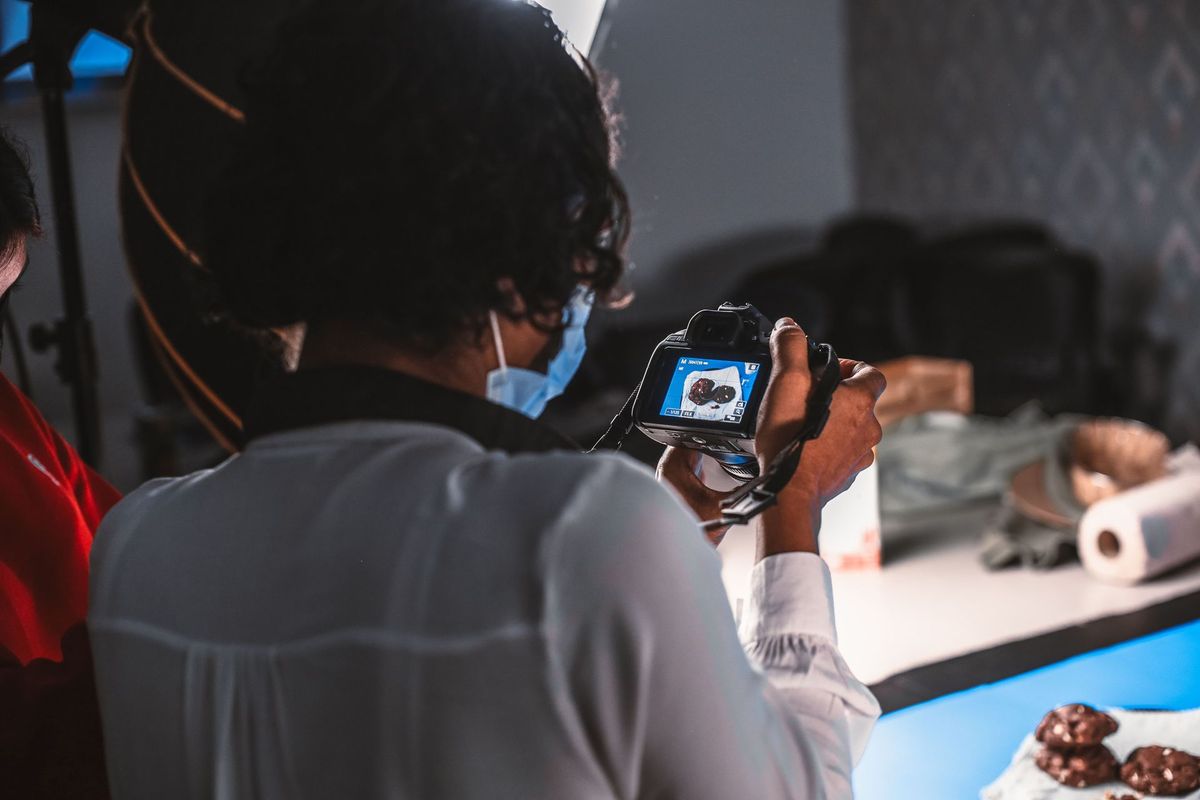 A photographer shoots a dessert product under studio light
