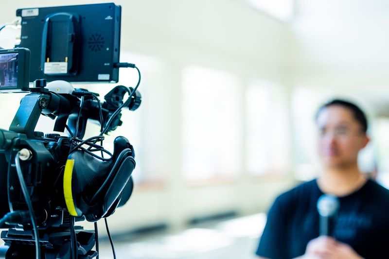 A professional camera set up for an interview with the background softly blurred