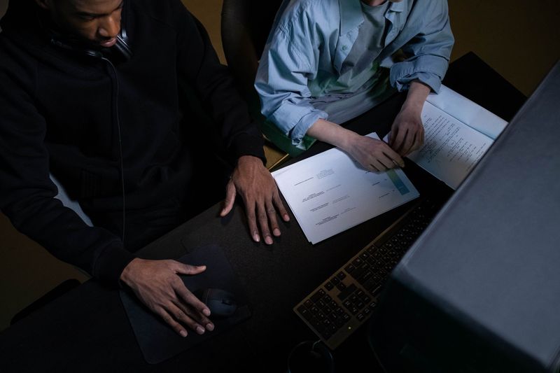 Colleagues sitting at a desk and working together