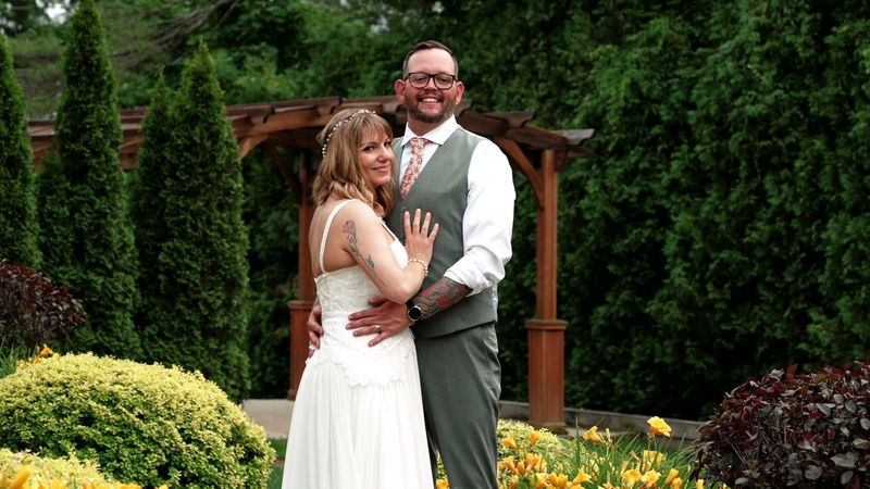 Tyler and Sara smile together during garden portraits